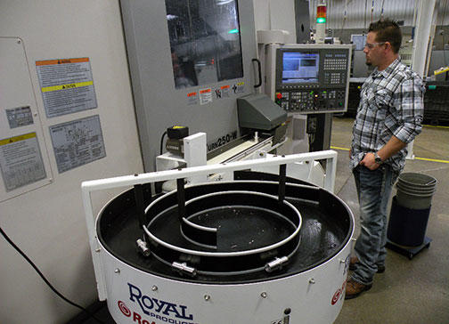 Programmer Rich Stenberg monitors a run of the upper spring on the Okuma MacTurn, which is equipped with a bar feeder, tool magazine, and parts accumulator for 10–12-hr untended operation