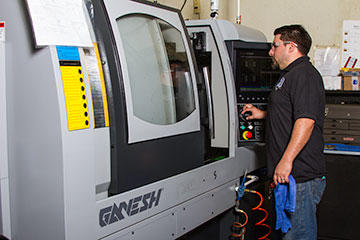 Robert Marcos Alvarado, set-up machinist for lathe and multi-task machines (and Jesse’s nephew) tests a job set-up on a Ganesh Cyclone 32CS 7-axis multi-task machine.