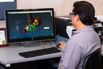 Shop owner, machinist and CNC programmer, Jesse Alvarado, verifies a toolpath in GibbsCAM Cut Part Rendering. The software also lets him save any machining pass as his new “stock,” which allows him to rotate the part (or move it to another machine) to machine from another side, and get smooth blends.