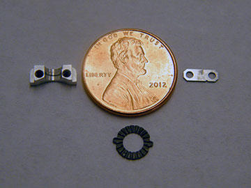Far from Progressive Tool’s beginnings, these parts represent a new specialization: tiny components for strategic and tactical defense. Pictured left to right are a machined adjustment clamp for a satellite, a detent for optical adjustment of a night-vision goggle and a part for a satellite circuit board.