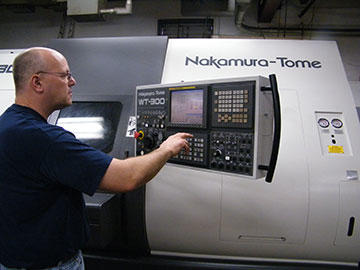CNC lathe supervisor Brian Fish sets up an NC program generated with GibbsCAM, which he uses to program various lathes, a dualspindle Takisawa, a Nakamura Tome 150 with live tooling and this eight-axis Nakamura MTM.