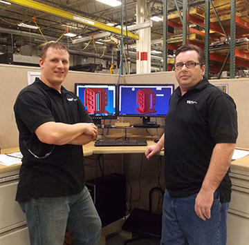 Programmers Kevin Hjelmgren and Kevin Warlow with tombstone simulation at one of Wilson Tool’s GibbsCAM stations on the shop floor