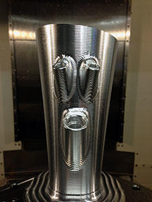A completed runner, programmed with GibbsCAM 5-Axis software and machined from aluminum billet in 4-axis, has a wall thickness of .090”, replaces sheet metal fabrication. Built-in bongs eliminate the previous welding and manual machining required for sheet metal runners.