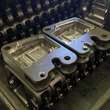 A group of PR-A2 parachute release cases in the process of machining. These prototypes were machined from solid billet of 17-4 PH stainless steel.