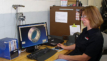 Multi-task machine and lathe programmer-machinist Tamara Hawn reviews a part to be machined on the Integrex 300 with CNC program from GibbsCAM MTM. Of the many GibbsCAM features she uses repeatedly, Hole Wizard, which categorizes bores and holes, and automates programming the various drill cycles, is one of her favorites.