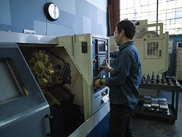 Standard Metal Products owner, Kevin Binkert, sets up a job on his Mori Seiki CL25B lathe.