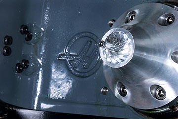 The Haas trunnion on VF-4 machining center shows an aluminum impeller after machining.