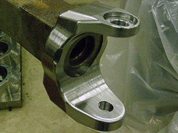 Like this finished C, many Ouverson axle components are perfect candidates for plunge roughing. Because much of the work is custom, castings are not an economical alternative to machining from a billet.