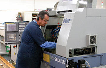 Dennis Shiver, sets up one of 2 7-axis Star Swiss screw machines in operation at Inverse Solutions, Inc.