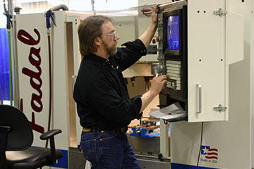 Jerome Jasmer makes adjustments to a prototype on a Fadal VMC15-XT with a 32MP controller fed by Ethernet card for instant transfer of files from desktop computer. No RS232 drip feed here, speed and efficiency are the name of the game.