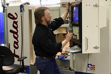 Jerome Jasmer makes adjustments to a prototype on a Fadal VMC15-XT with a 32MP controller fed by Ethernet card for instant transfer of files from desktop computer. No RS232 drip feed here, speed and efficiency are the name of the game.
