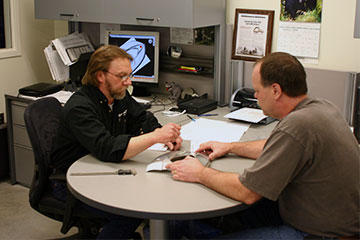 Jerome Jasmer discusses issues encountered on the Victory Vegas Jackpot passenger seat bracket with Gordon Nelson, Design Technologist.